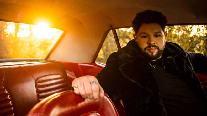 Eurovision singer James Newman poses in a car