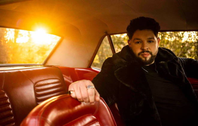 Eurovision singer James Newman poses in a car